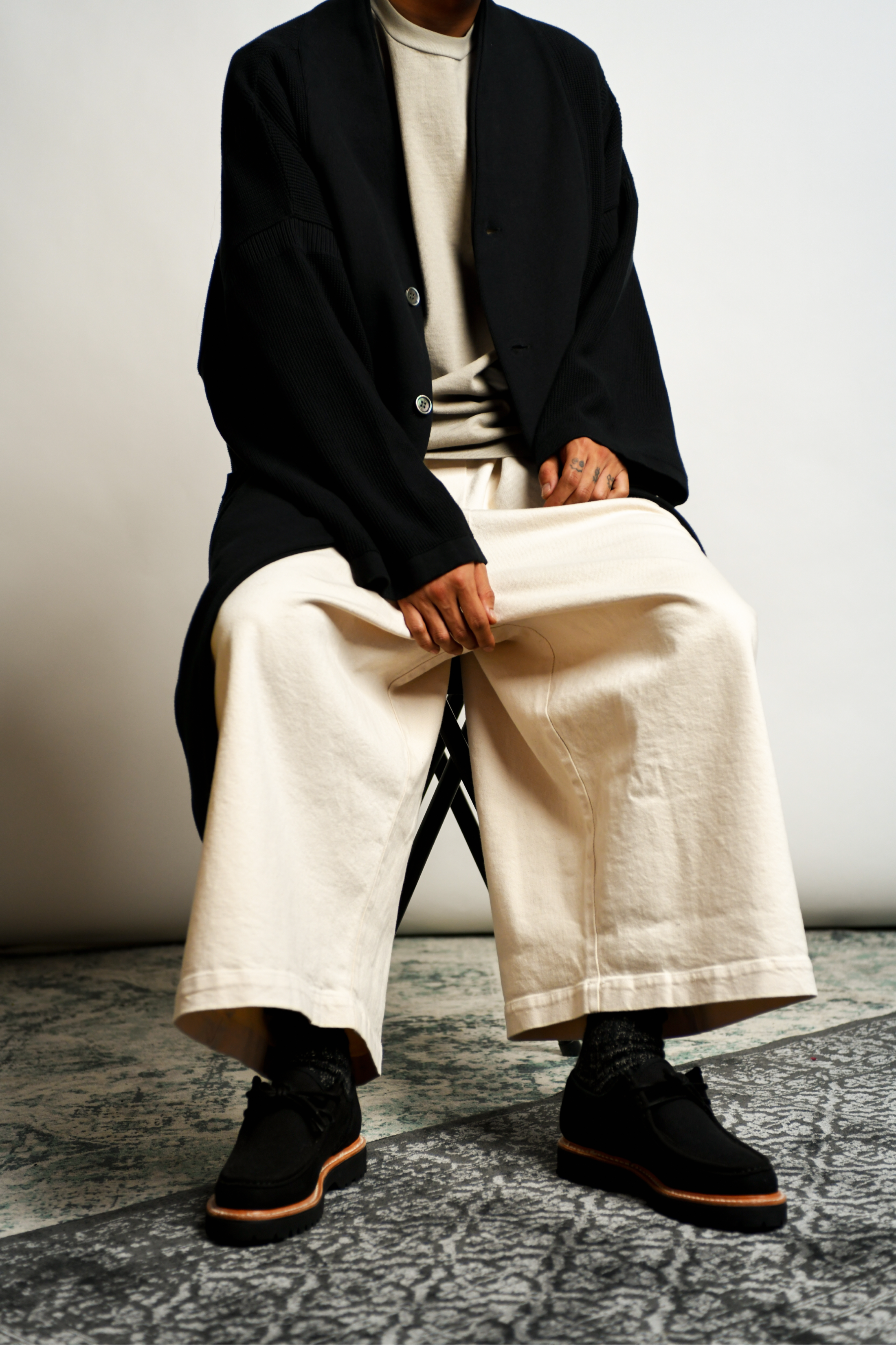 Man sitting wearing knitted coat